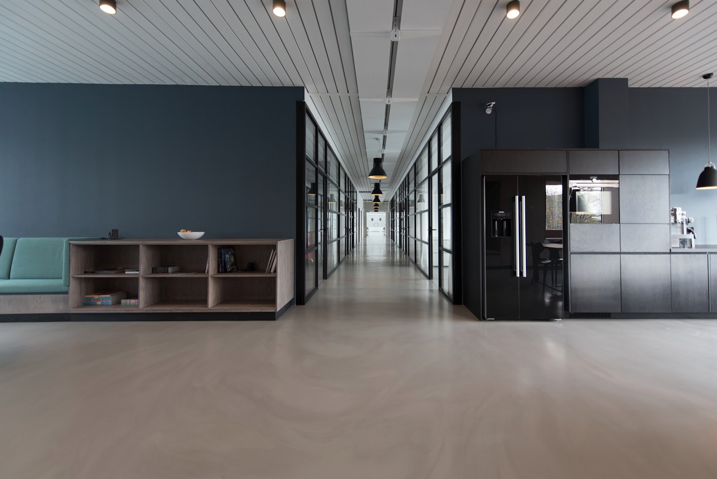 Modern office common area with kitchen and lounge seating