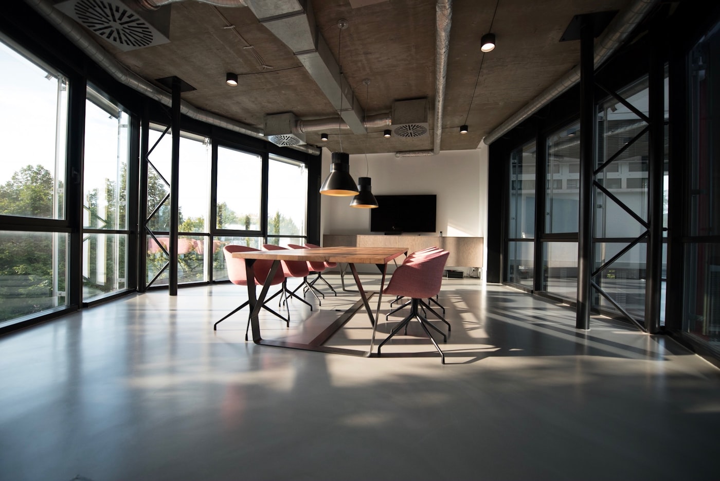 Modern conference room with a long table and floor-to-ceiling windows