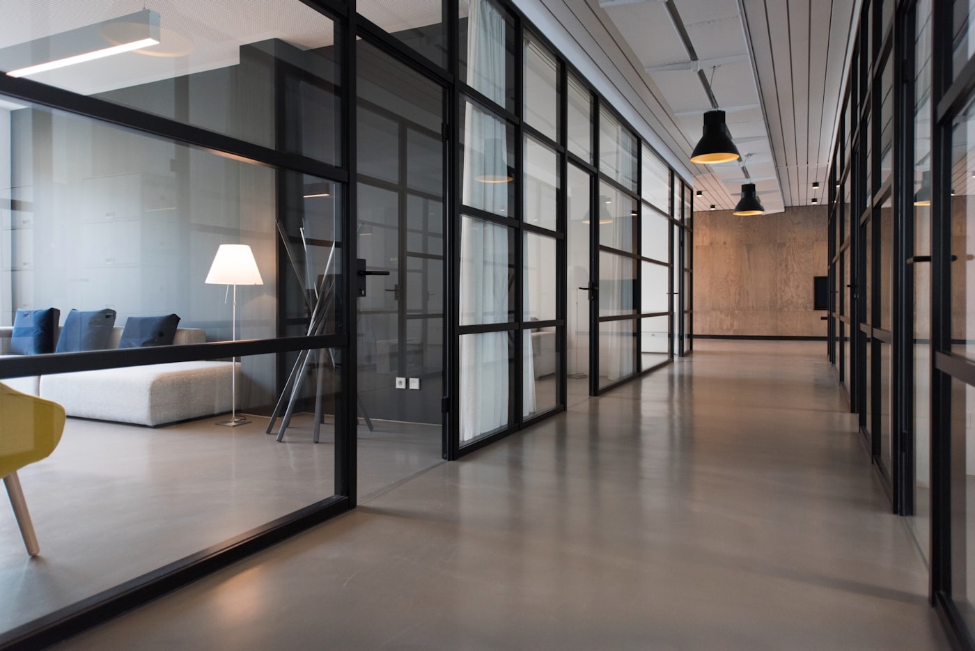 Glass-partitioned office corridor with clean interior windows